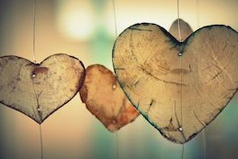 Wooden hearts hanging together: HeartStrong